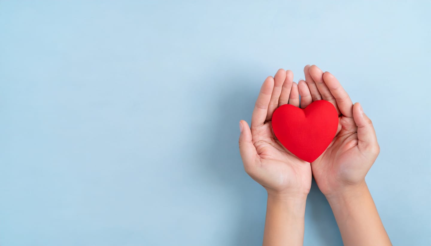 hands-holding-red-heart-blue-background-world-heart