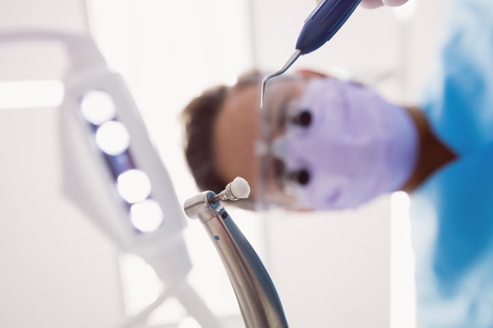 dentist holding instruments