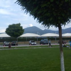 Parking canopy at Uva Nestum, blending harmoniously into the surrounding green landscape.