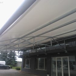 Detailed underside view of the textile canopy roof at Sanitex parking zone.