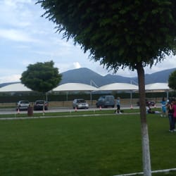 Parking canopy at Uva Nestum, blending harmoniously into the surrounding green landscape.