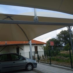 Underneath view of module with visible arched beams from parking canopy structure